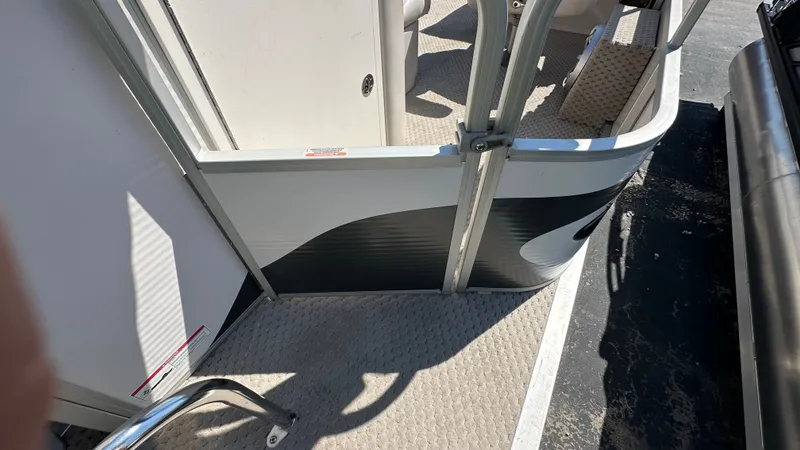 Slide: The Image of Partial view of a 2008 Manitou Legacy pontoon boat with gray flooring and seating area. - 5