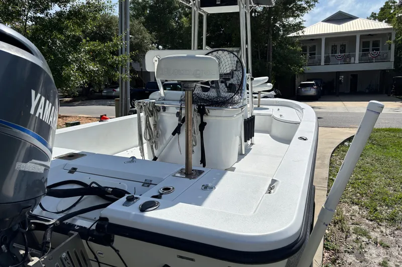 Slide: The Image of 2006 Ranger 2200 Bay Ranger boat with Yamaha engine, parked in a residential driveway. - 6