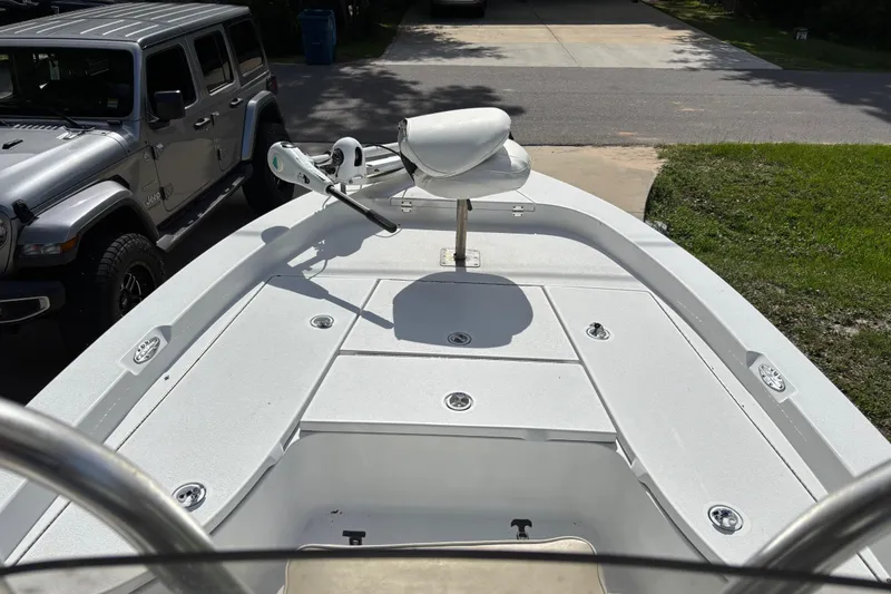Slide: The Image of 2006 Ranger 2200 Bay Ranger boat with trolling motor, parked beside a silver Jeep. - 7