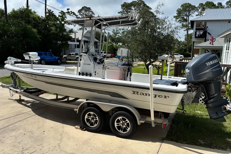 Slide: The Image of 2006 Ranger 2200 Bay Ranger boat with Yamaha engine on a trailer in a residential area. - 3