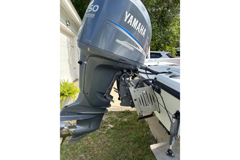 Slide: The Image of 2006 Ranger 2200 Bay Ranger boat with Yamaha outboard motor in a driveway setting. - 9