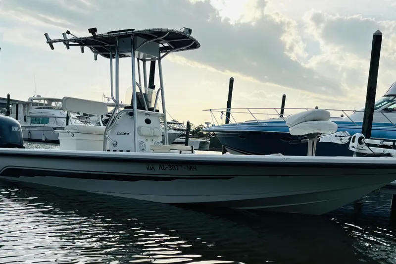 Slide: The Image of 2006 Ranger 2200 Bay Ranger boat docked at marina, under cloudy sky. - 12