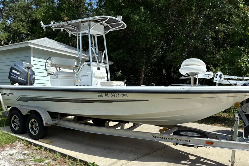 The Image of 2006 Ranger 2200 Bay Ranger boat on trailer with Yamaha motor, parked outdoors. - 0