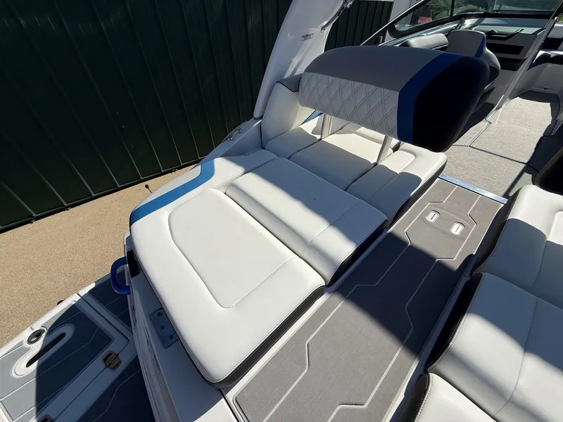 Slide: The Image of The image shows the interior of a 2019 Regal 23 RX Bowrider with white upholstery. - 32