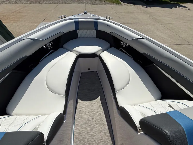 Slide: The Image of The image shows the bow area of a 2019 Regal 23 RX Bowrider with white upholstery. - 10