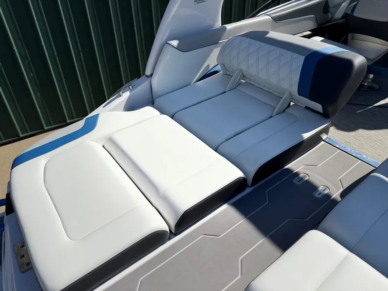 Slide: The Image of The image shows the luxurious white and blue seating of a 2019 Regal 23 RX Bowrider. - 34
