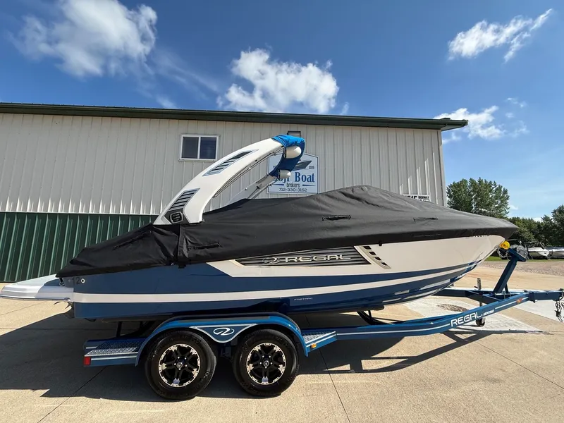 Slide: The Image of A 2019 Regal 23 RX Bowrider on a trailer, covered with a black tarp. - 42
