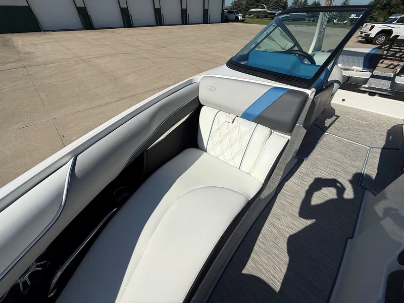 Slide: The Image of Interior view of a 2019 Regal 23 RX Bowrider with white upholstery and blue accents. - 12