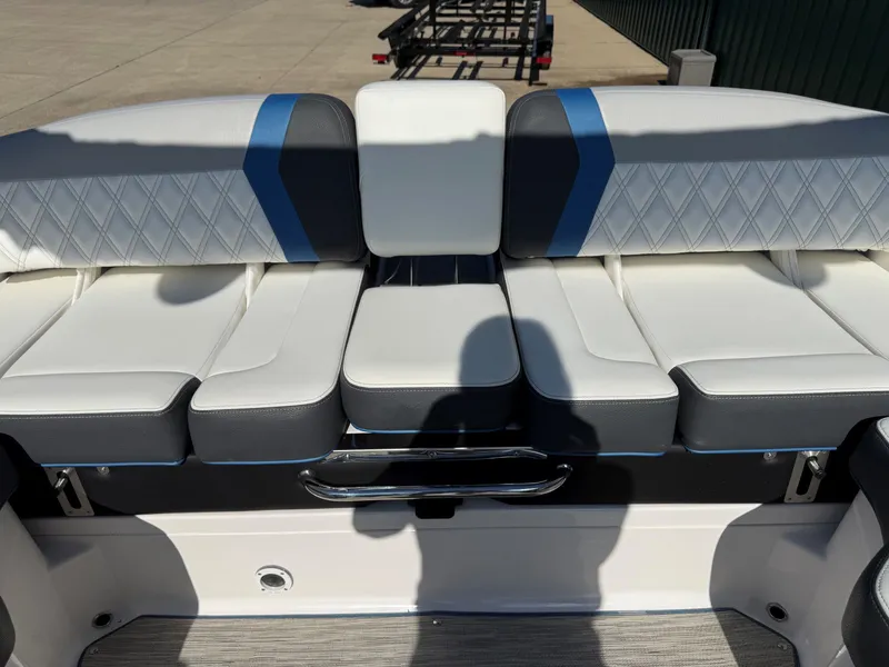 Slide: The Image of Rear seating of a Regal 23 RX Bowrider with white and blue upholstery. - 29