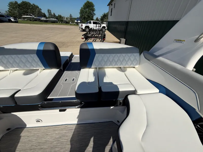 Slide: The Image of Interior view of a 2019 Regal 23 RX Bowrider with white and blue seating. - 26