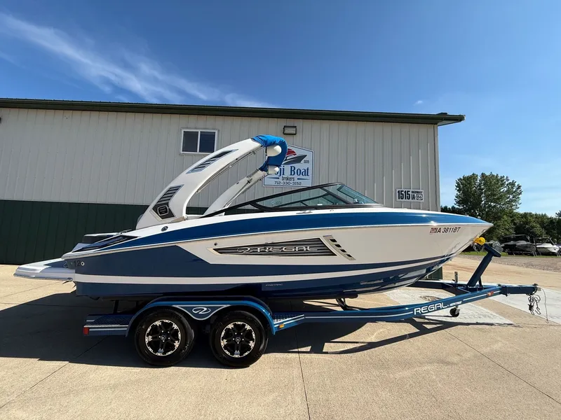 Slide: The Image of A 2019 Regal 23 RX Bowrider on a trailer in front of a building. - 43