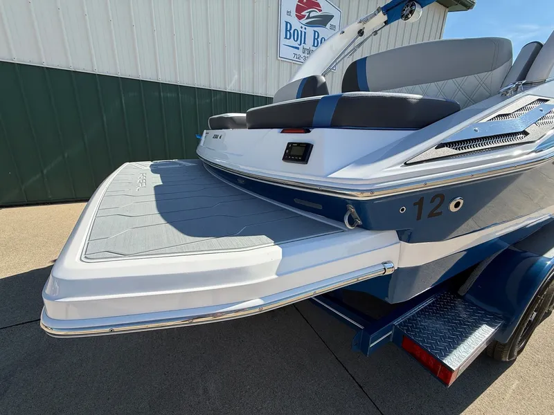 Slide: The Image of The image shows the rear of a 2019 Regal 23 RX Bowrider with a large swim platform. - 9