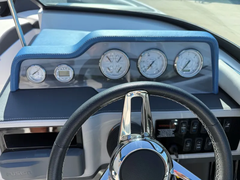 Slide: The Image of The dashboard of a 2019 Regal 23 RX Bowrider with multiple gauges and a steering wheel. - 17
