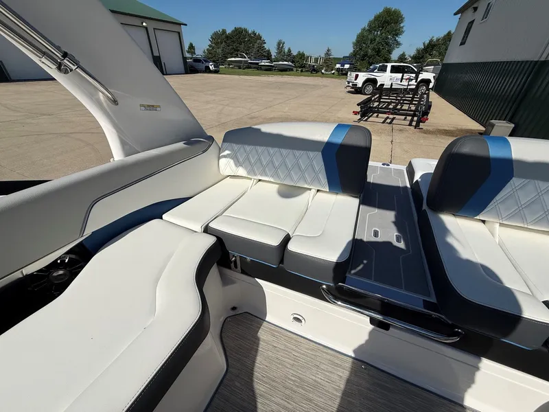 Slide: The Image of The image shows the interior of a 2019 Regal 23 RX Bowrider with white and blue seating. - 27