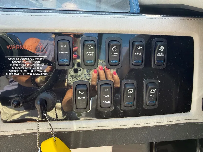 Slide: The Image of Control panel of a Regal 23 RX Bowrider with various switches and warning labels. - 20