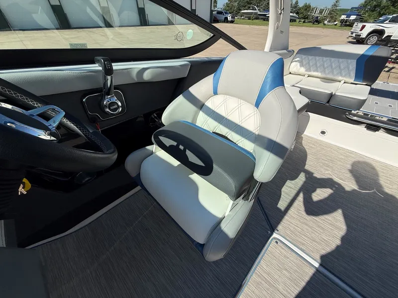 Slide: The Image of Interior view of a 2019 Regal 23 RX Bowrider with gray and blue seating. - 23
