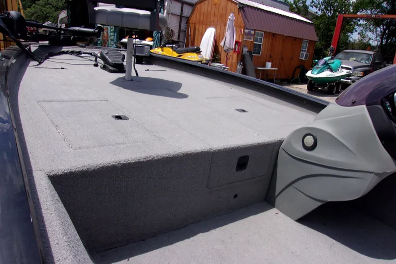 Slide: The Image of 2013 Tracker Pro Team 190 TX boat interior with gray carpet and seating. - 9