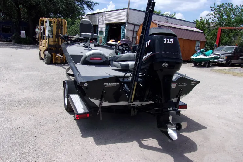 Slide: The Image of 2013 Tracker Pro Team 190 TX boat with Mercury 115 engine, parked outdoors. - 4