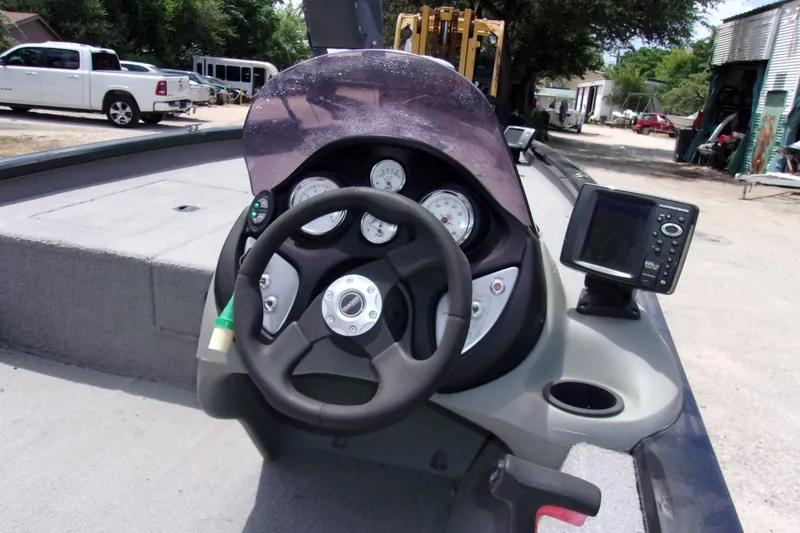 Slide: The Image of 2013 Tracker Pro Team 190 TX boat dashboard with steering wheel and fish finder. - 5