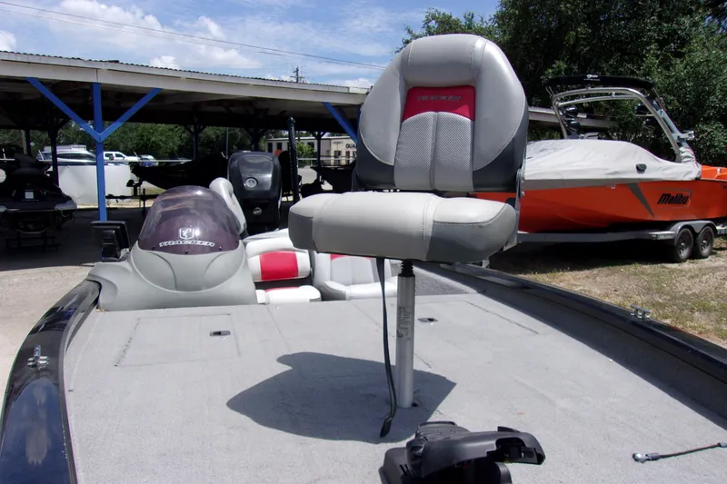 Slide: The Image of 2013 Tracker Pro Team 190 TX fishing boat with elevated seat, parked outdoors. - 11