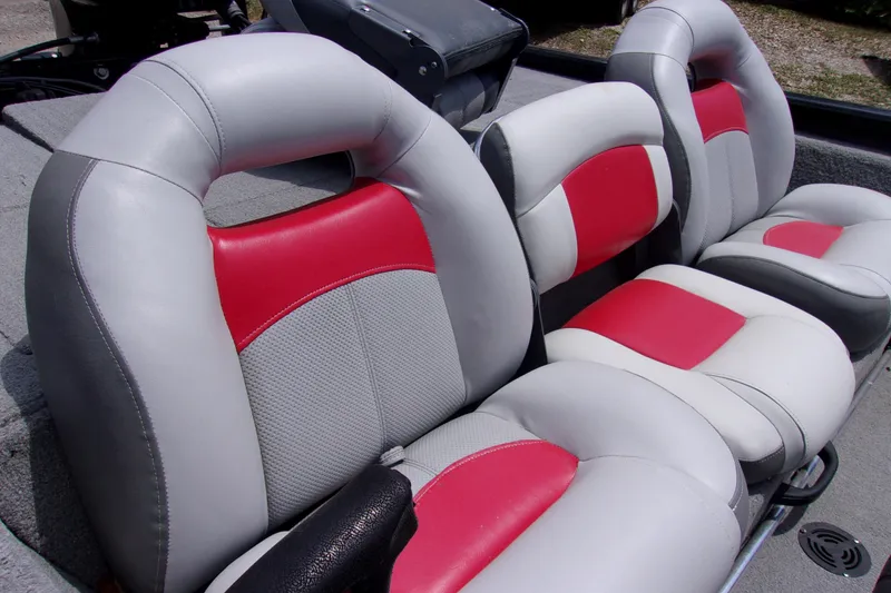 Slide: The Image of 2013 Tracker Pro Team 190 TX boat seats with red and gray upholstery. - 6