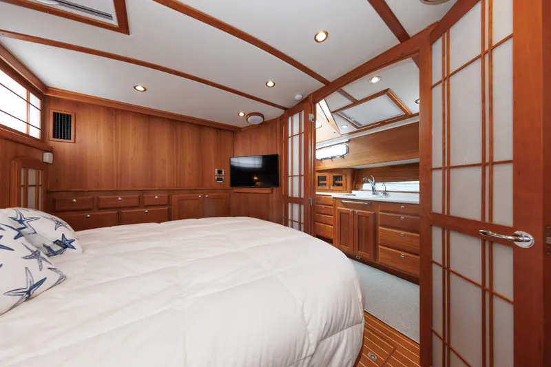 Slide: The Image of Luxurious 2024 Sabre 48 Salon Express bedroom with wood paneling and modern amenities. - 33