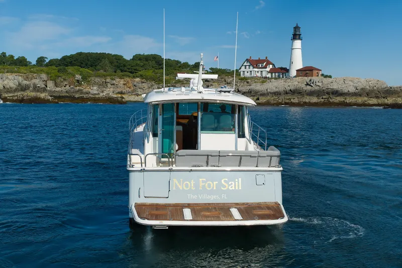 Slide: The Image of 2024 Sabre 48 Salon Express yacht near lighthouse, ocean view. - 3