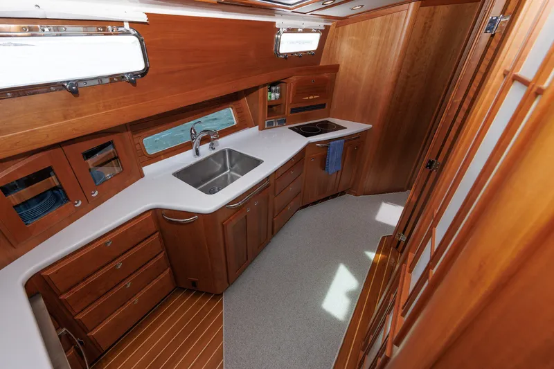 Slide: The Image of Luxurious 2024 Sabre 48 Salon Express yacht interior with modern kitchen and wooden cabinetry. - 17