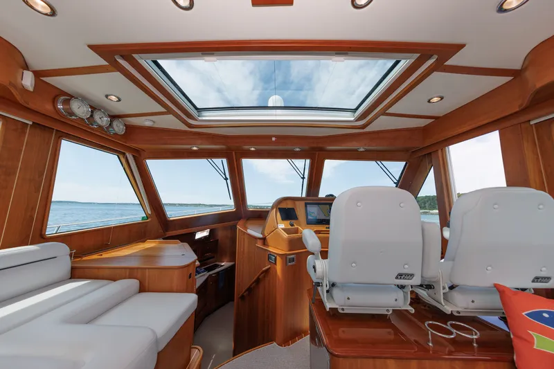 Slide: The Image of Interior of 2024 Sabre 48 Salon Express yacht with luxurious seating and panoramic windows. - 25