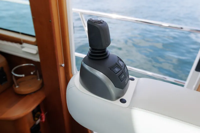 Slide: The Image of Joystick control on 2024 Sabre 48 Salon Express yacht, overlooking ocean. - 29