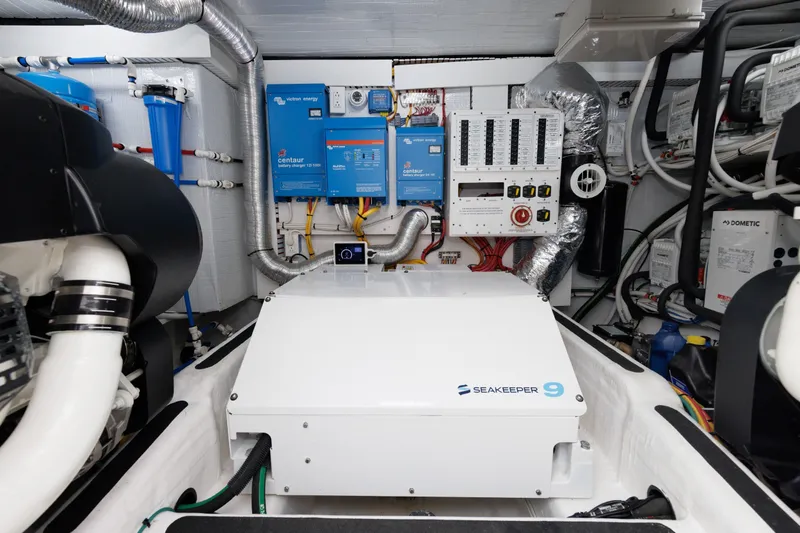 Slide: The Image of Engine room of 2024 Sabre 48 Salon Express with Seakeeper 9 stabilizer and electrical systems. - 38