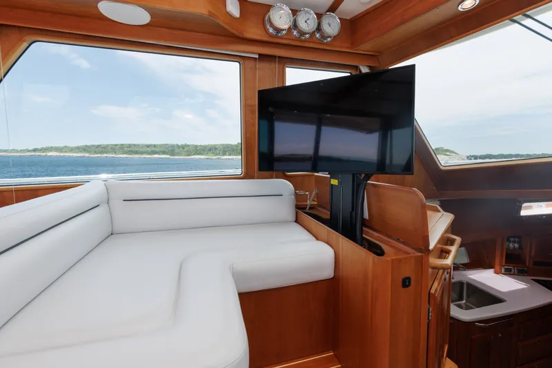 Slide: The Image of Luxurious interior of 2024 Sabre 48 Salon Express yacht with plush seating and scenic ocean view. - 23