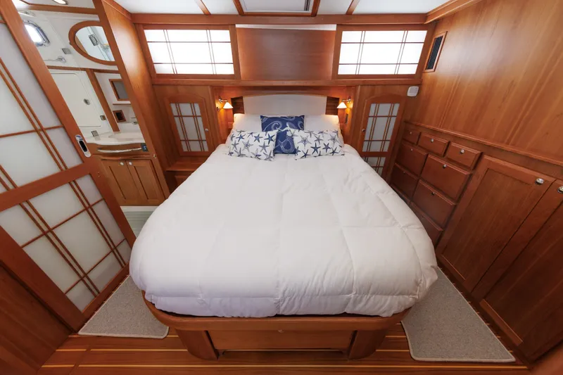 Slide: The Image of Luxurious 2024 Sabre 48 Salon Express cabin with elegant wood finish and cozy bedding. - 32