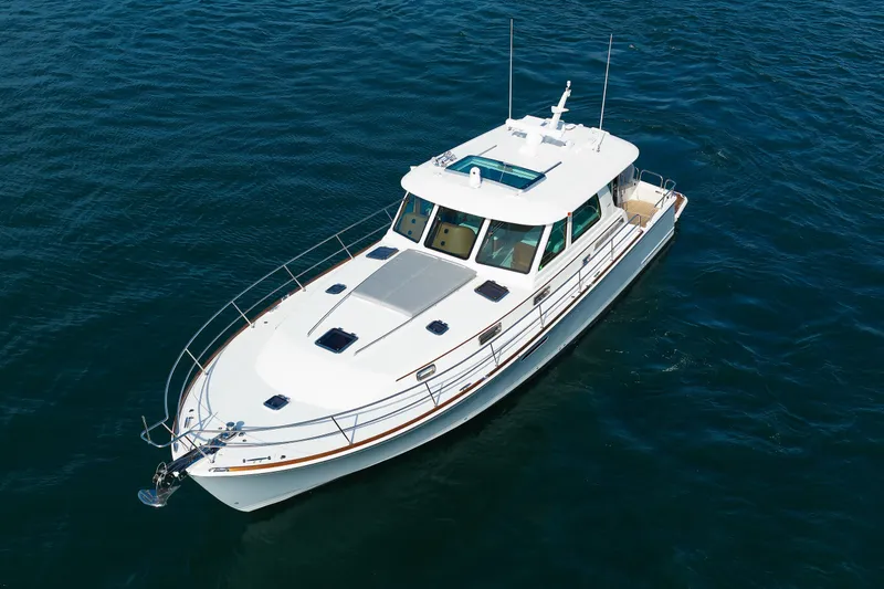 Slide: The Image of 2024 Sabre 48 Salon Express yacht cruising on open water. - 6