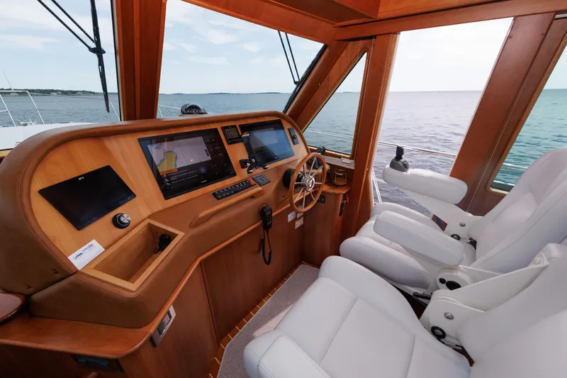 Slide: The Image of 2024 Sabre 48 Salon Express helm with modern navigation systems and luxurious seating. - 28