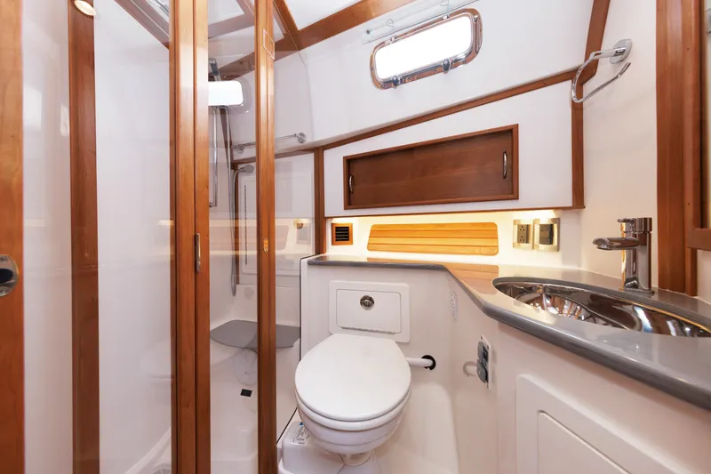 Slide: The Image of Luxurious bathroom interior of 2024 Sabre 48 Salon Express yacht, featuring wood accents and modern fixtures. - 34