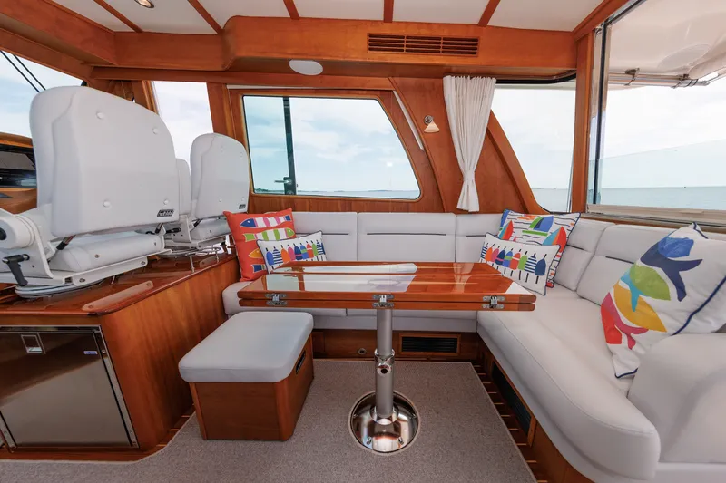 Slide: The Image of Luxurious interior of 2024 Sabre 48 Salon Express yacht with colorful cushions and wooden accents. - 22