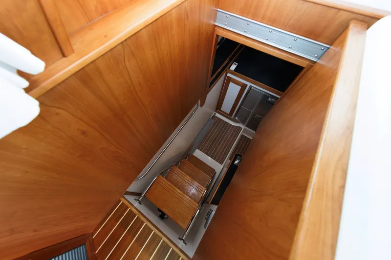 Slide: The Image of Staircase inside 2024 Sabre 48 Salon Express yacht, featuring elegant wooden design. - 35
