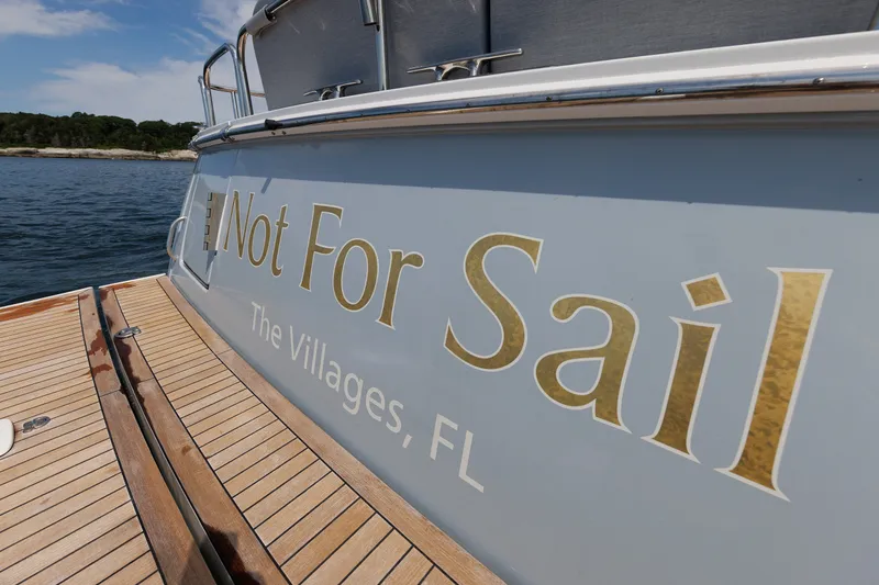 Slide: The Image of 2024 Sabre 48 Salon Express yacht with "Not For Sail" lettering, docked near The Villages, FL. - 14