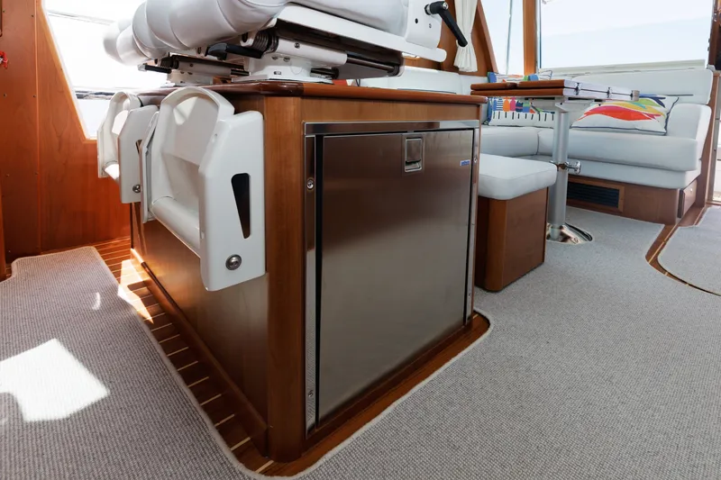 Slide: The Image of 2024 Sabre 48 Salon Express interior with seating, table, and stainless steel appliance. - 26