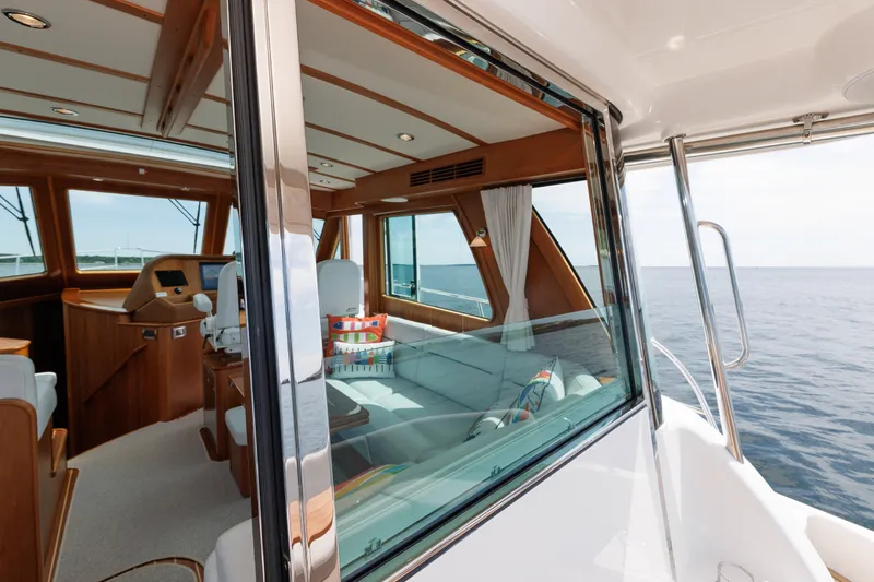 Slide: The Image of 2024 Sabre 48 Salon Express interior with luxurious seating and ocean view. - 15