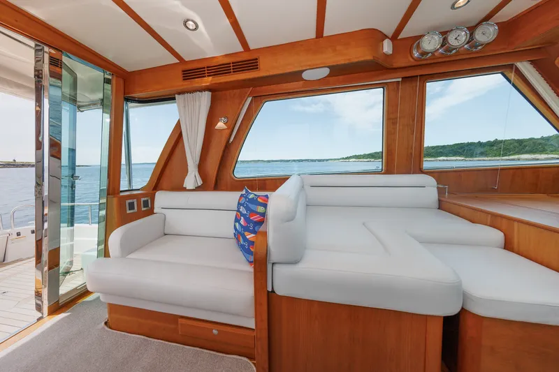 Slide: The Image of Luxurious interior of 2024 Sabre 48 Salon Express yacht with white seating and ocean view. - 21
