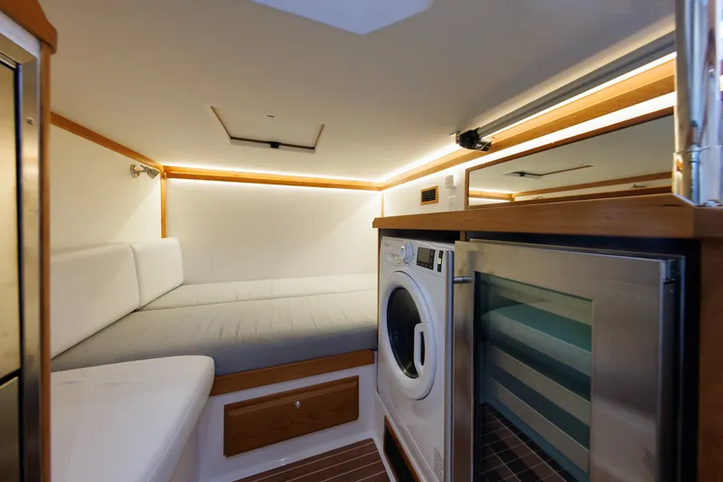 Slide: The Image of 2024 Sabre 48 Salon Express interior with bed, washer, and fridge. - 37