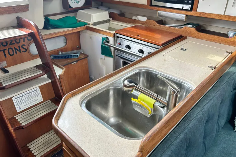 Slide: The Image of Interior of 1998 Catalina 36 MkII sailboat featuring kitchen sink and stove area. - 91