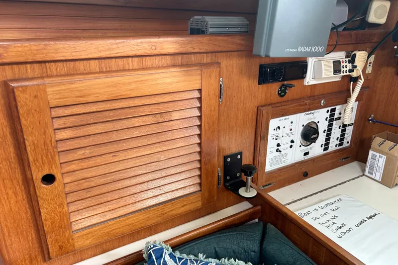 Slide: The Image of Interior of a 1998 Catalina 36 MkII sailboat with control panel and wooden cabinetry. - 66