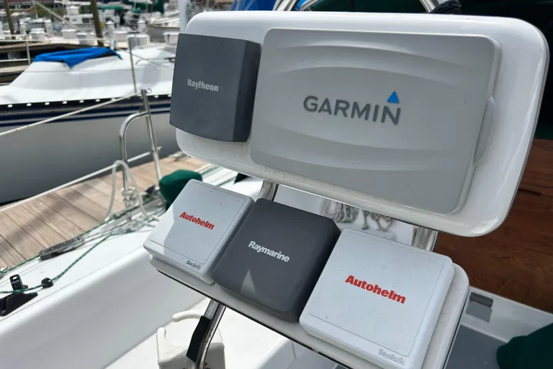 Slide: The Image of Navigation equipment on a 1998 Catalina 36 MkII sailboat, featuring Garmin, Raytheon, and Autohelm devices. - 26