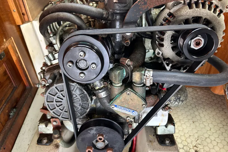Slide: The Image of Engine compartment of a 1998 Catalina 36 MkII sailboat, featuring belts and hoses. - 36