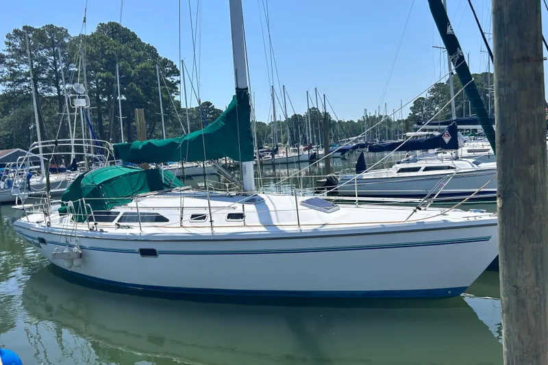 Slide: The Image of 1998 Catalina 36 MkII sailboat docked in a marina, surrounded by other boats. - 4