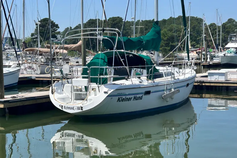 Slide: The Image of Sailboat Catalina 36 MkII, 1998 model, docked in a marina with green cover. - 6