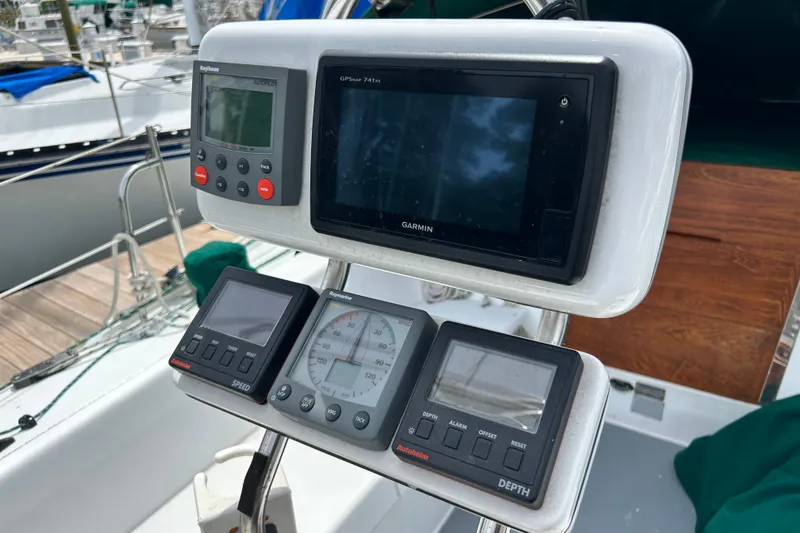 Slide: The Image of Cockpit instruments on a 1998 Catalina 36 MkII sailboat, featuring Garmin and Raytheon displays. - 25